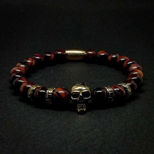 Gold Skull with red tiger eye.